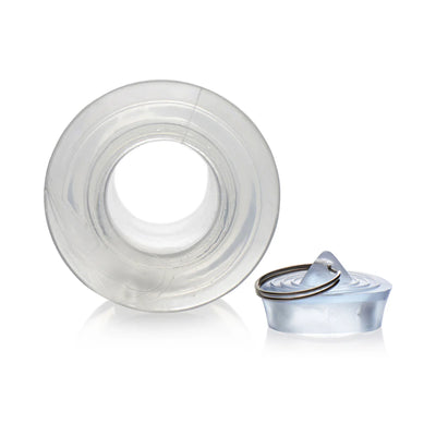 Transparent hollow anal dilator with removable plug featuring a metal ring, shown on white background.
