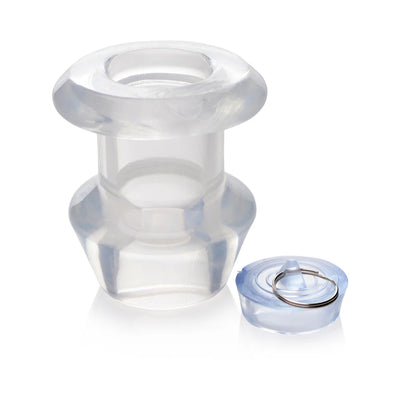 Transparent hollow anal dilator with removable plug, made of firm yet flexible clear TPE material.