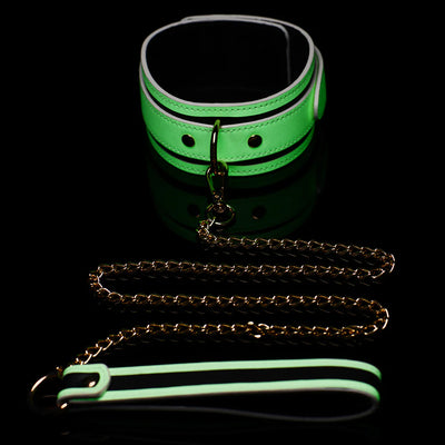 Glowing green PU leather collar with gold metal hardware and matching gold chain leash on black background.