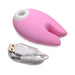 Pink silicone clitoral stimulator with dual bunny ears and USB charging cable on white background.