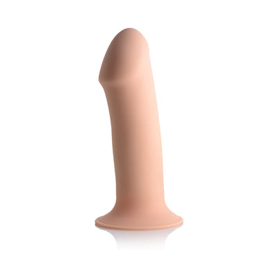 Beige squeezable phallic dildo with suction cup base made of smooth silicone, standing upright on a white background.