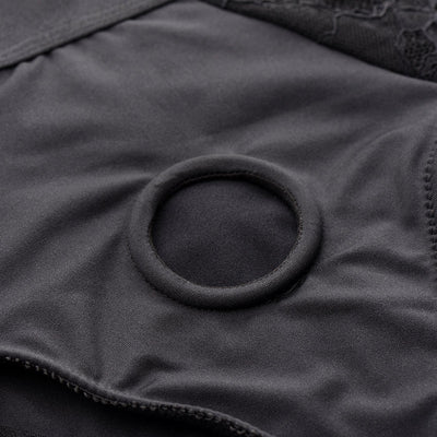 Close-up of black panty harness with circular O-ring and lace detailing, designed for comfort and support.