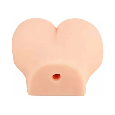 Compact flesh-toned dual-entry vibrating masturbator with smooth, rounded design and single visible opening.