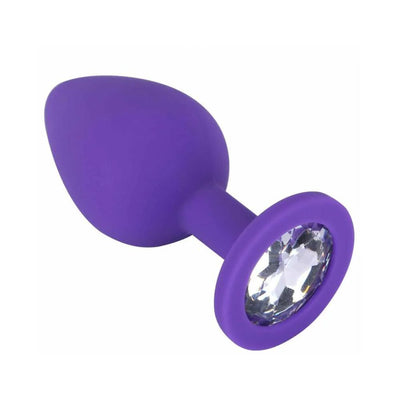 Purple silicone butt plug with tapered tip and clear jewel base for training and pleasure.