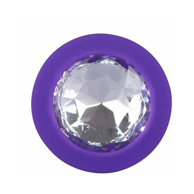 Close-up of a purple silicone base with a large clear faceted jewel accent from a Me You Us butt plug set.