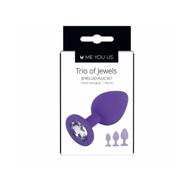 Purple silicone butt plug with jeweled base shown on white packaging for Me You Us Trio of Jewels 3-piece training set.