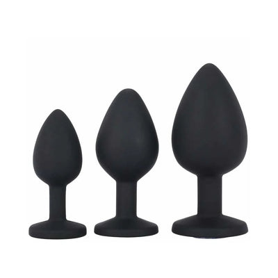 Set of three black silicone tapered training plugs in small, medium, and large sizes with flat bases.