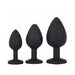 Set of three black silicone tapered training plugs in small, medium, and large sizes with flat bases.