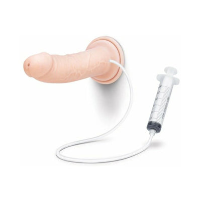 Realistic 8-inch vanilla-colored dildo with squirting feature and attached syringe for fluid filling, suction base for hands-free use.