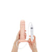 Hands holding a realistic 8-inch vanilla-colored dildo with a syringe attached for squirting feature.