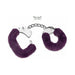 Purple furry handcuffs with metal chain and two small silver keys on white background.
