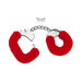 Red furry handcuffs with metal chain and two small silver keys on white background.
