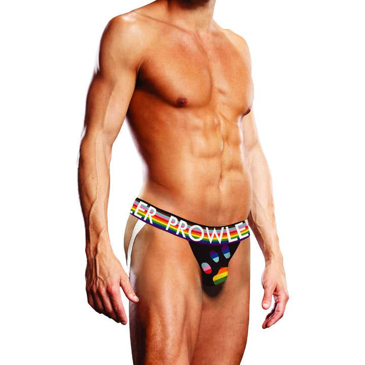 Male model wearing Prowler Black Oversized Paw Jock with rainbow waistband and paw print design on front pouch.
