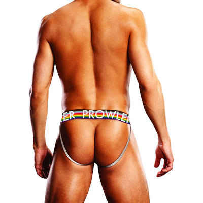 Rear view of a man wearing a Prowler Black Oversized Paw Jock with a rainbow waistband and minimal coverage straps.