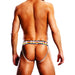 Rear view of a man wearing a Prowler Black Oversized Paw Jock with a rainbow waistband and minimal coverage straps.