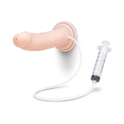 Realistic nude-colored squirting dildo with suction base and attached syringe for filling, shown on white background.