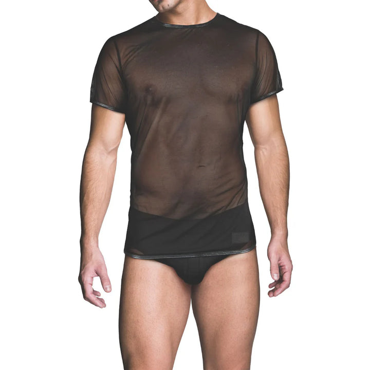 Male model wearing a black sheer mesh short sleeve t-shirt with black briefs against a white background.