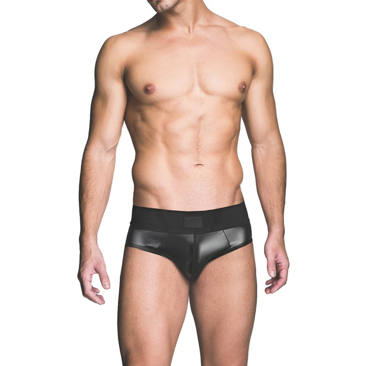 Male model wearing black wetlook brief with wide waistband against white background