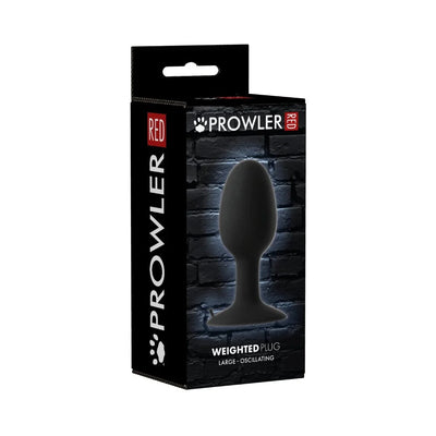 Prowler Xlarge weighted butt plug in black with packaging showing product image and branding on a dark brick background.