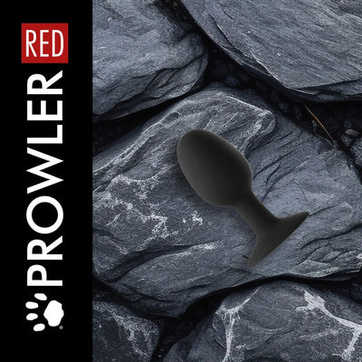 Black Prowler Xlarge weighted butt plug displayed on textured dark gray stone background.
