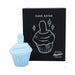 Light blue silicone cupcake-shaped flicker stimulator with power button, shown next to black packaging box with white cupcake illustration.