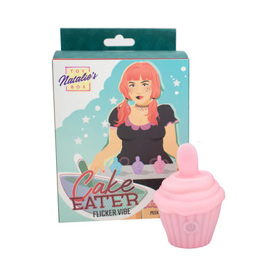Pink silicone cupcake-shaped flicker stimulator with packaging featuring illustrated woman and product name Cake Eater Flicker Vibe.