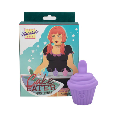 Purple silicone cupcake-shaped flicker stimulator with packaging featuring illustrated woman holding cupcakes.