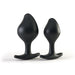 Two black silicone anal plugs with tapered tips and flared bases, designed for comfortable and safe use.