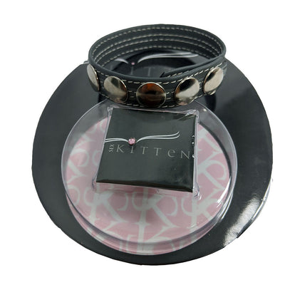 Black leather adjustable ring with five silver snaps displayed on branded packaging
