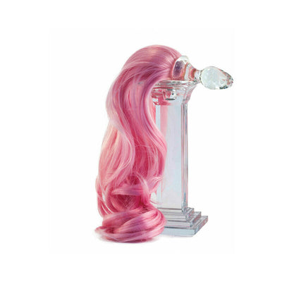 Clear glass anal plug with long, curly pink ponytail attached, displayed on a transparent pedestal.