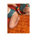 Two people in teal underwear with rainbow wristbands near a rainbow-colored dildo on an orange shag carpet