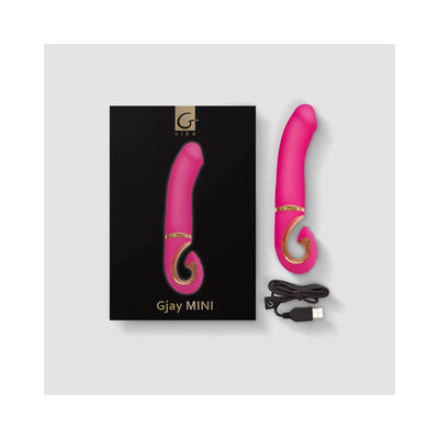 Gvibe Gjay MINI Wildberry vibrator in bright pink with gold accents, shown with packaging and USB charging cable.