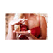 Woman in red dress holding Eye of Love Matchmaker Pheromone Perfume in a red diamond-shaped bottle