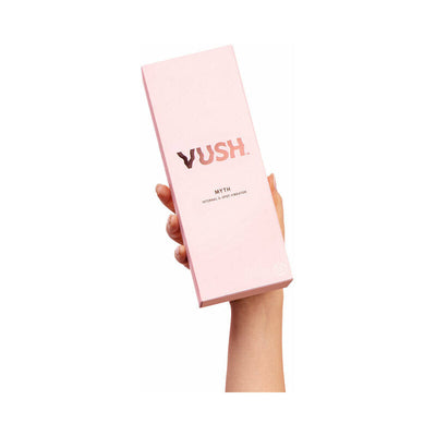 Hand holding pink box packaging of VUSH Myth G-Spot Vibrator with rose gold logo and text on white background.