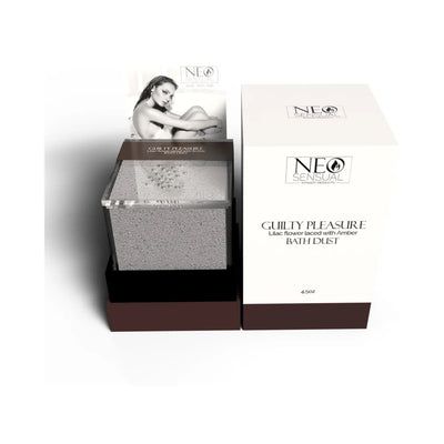 Neo Sensual Guilty Pleasure bath dust in clear container with white and brown packaging featuring lilac and amber scent description.