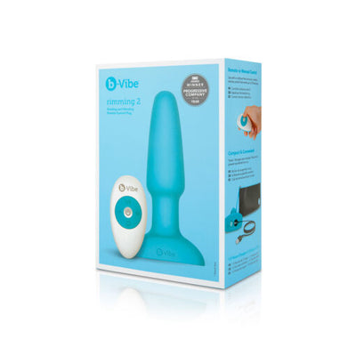 Packaging of B-Vibe Rimming Plug 2 showing a teal silicone plug and white wireless remote control on a light blue background.