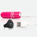 Pink bullet vibrator with USB charging cable and black remote control ring on white background.