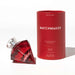 Red diamond-shaped perfume bottle with clear cap next to matching red cylindrical packaging for Matchmaker pheromone parfum.