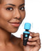 Woman holding a compact black and blue BANG! 10X Vibrating Mini Wand with flexible neck and vibrating head.