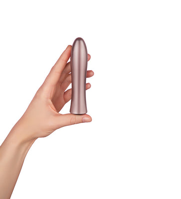 Hand holding a sleek, metallic rose gold bullet vibrator with a smooth, tapered design against a white background.