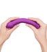 Hands bending a textured purple silicone wand designed for targeted stimulation and comfort.