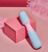 Compact Femme Funn Ffix Mini Wand vibrator in pastel blue and pink on a pink box with feather accents