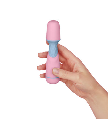 Hand holding a compact pink and blue Femme Funn Ffix Mini Wand vibrator against a white background.