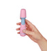 Hand holding a compact pink and blue Femme Funn Ffix Mini Wand vibrator against a white background.