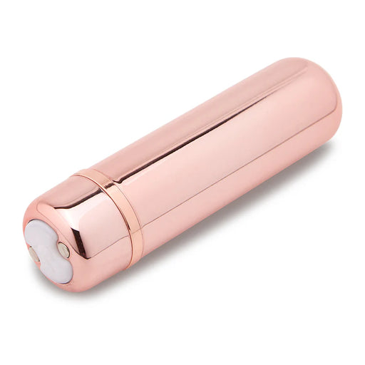 Rose gold compact bullet vibrator with smooth, sleek design and magnetic USB charging port on white background.