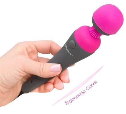 Hand holding Palmpower Massager with pink silicone head and ergonomic curved black handle against white background.