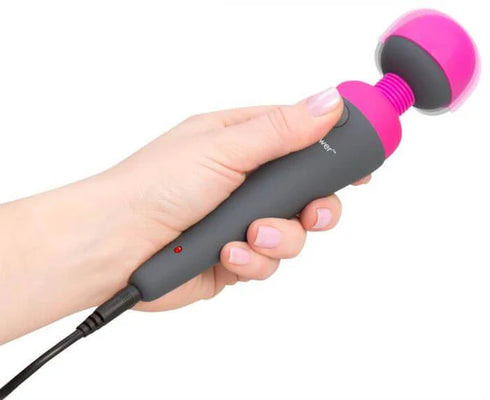 Hand holding a black and pink Palmpower Massager with a flexible head and attached power cord.