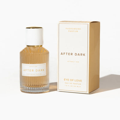 Eye of Love After Dark pheromone parfum 50ml in ribbed glass bottle with white and gold cap beside matching cream and gold box.