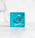 Blue swan-shaped finger vibrator in branded Queeni packaging on a light surface