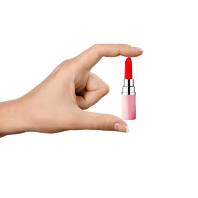 Hand holding compact coral lipstick-shaped vibrator with sleek pink and silver casing on white background